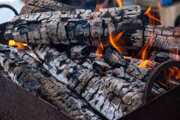 Firewood is burning in place for a fire close-up.