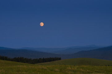full moon over the mountains