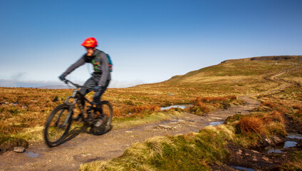 Fototapeta na wymiar Mountain Biker downhill - descending Ingleborough, Yorkshire