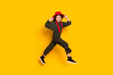 Fototapeta na wymiar Full length body size profile side view of lovely glad cheerful girl jumping running having fun isolated over bright yellow color background