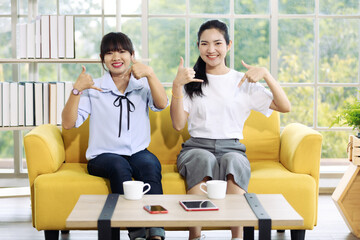 Young and beautiful Asain women sitting and demonstrat and communicate with hand sign, deaf language.