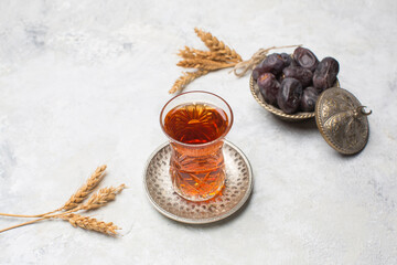 Tea in traditional Azerbaijan pear shape glass and dry dates