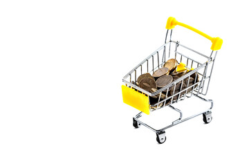Coins inside a yellow shopping basket on a white background. Isolated.