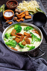 cream soup with broccoli and croutons in a pot