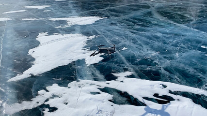 Obraz premium Launching a drone on the ice of frozen Lake Baikal off Olkhon Island.