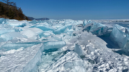 Fototapeta premium Ice hummocks of Lake Baikal covered with snow. Large, impenetrable chunks of ice.