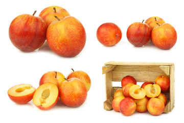 Naklejka na ściany i meble red and yellow plums and some in a wooden crate on a white background