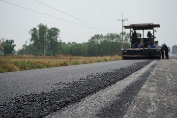 The image is blurred in the construction of asphalt road.