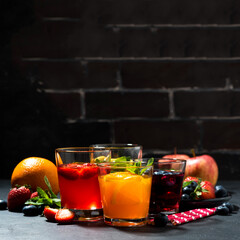 fruit lemonades in assortment and dark background