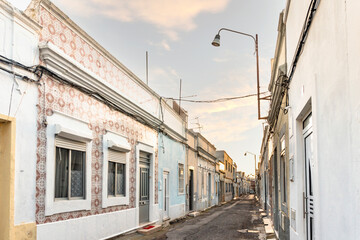 Small houses on the narrow street of historic Olhao, Algarve, Portugal