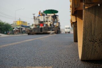 The image is blurred in the construction of asphalt road.