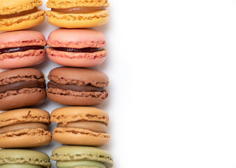 several multi-colored macaroon cakes on a white background