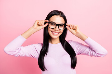 Photo of young beautiful happy positive good mood smiling girl wearing glasses isolated on pink...