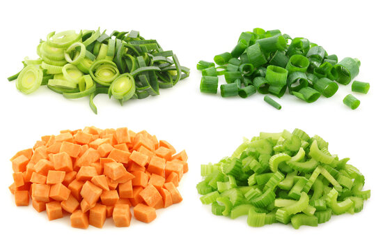 Cut leek, celery, spring onion and brunoise cut sweet potato pieces on a white background