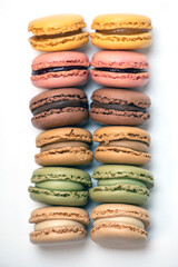 several multi-colored macaroon cakes on a white background