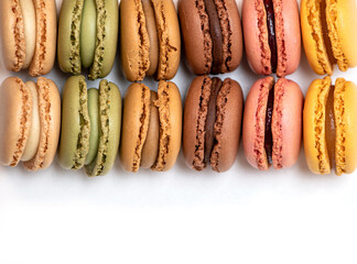 several multi-colored macaroon cakes on a white background