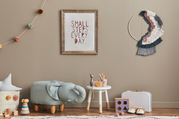 Stylish scandinavian kid room interior with toys, elephant pouf, plush animal toys, furniture, decoration and child accessories. Brown wooden mock up poster frames on the wall. Template