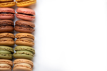 several multi-colored macaroon cakes on a white background