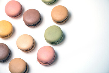 several multi-colored macaroon cakes on a white background
