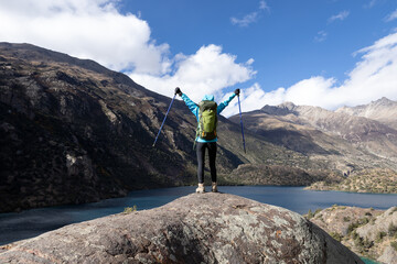 Woman backpacker hiking  in beautiful winter mountains