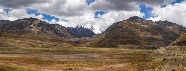 huge beautiful panorama landscape with enormous colourful mountains with ice during sunset in huaraz, peru