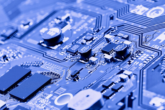 Electronic circuit board with electronic components such as chips close up. Blurry background.	