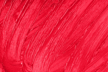 Red lipstick smear smudge sample texture background. Beauty product lop gloss closeup. Makeup creamy backdrop. Liquid beauty cream close up.