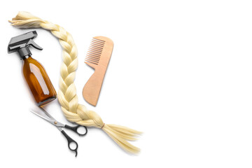 Hair strand with hairdresser's tools on white background