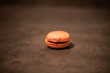 multicolored macaroon cakes on dark gray background