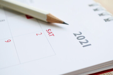 white pencil on 2021 calendar background business planning appointment meeting concept