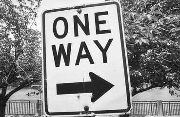 Black and white picture of One Way street sign in Roosevelt Island, New York City, USA.