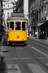 Fototapeta na wymiar Famous tram number 28 in Lisbon. Travel picture developed in post-production to isolate the yellow of the tram.