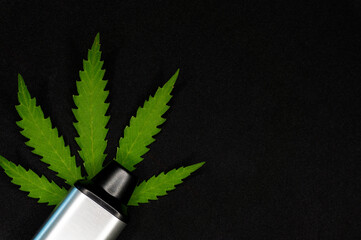electronic vaporizer for smoking with cannabis leaf on black background