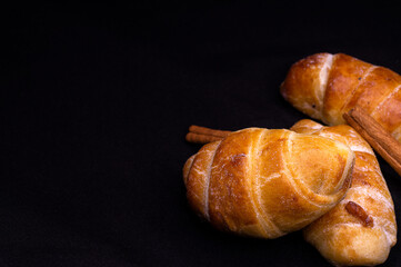 homemade mini croissants on black background