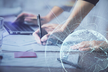 Double exposure of woman hands typing on computer and social network theme hologram drawing. People...