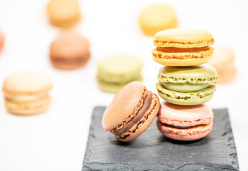 several multi-colored macaroon cakes on a white background