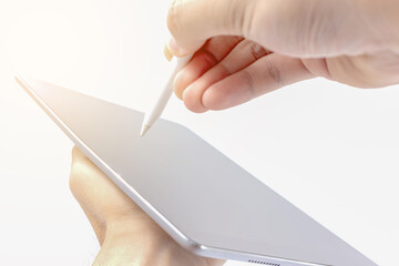 Close-up of working with stylus and digital tablet .Blurred background sun light,Horizontal closeup