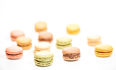 several multi-colored macaroon cakes on a white background