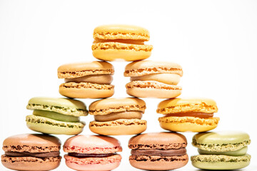 several multi-colored macaroon cakes on a white background