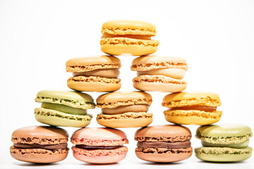 several multi-colored macaroon cakes on a white background