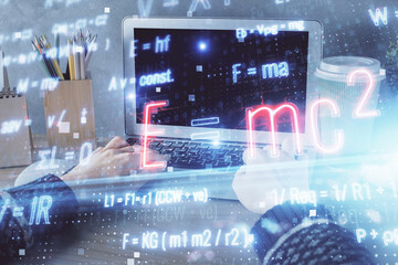 Double exposure of woman hands typing on computer and formula hologram drawing. Education concept.