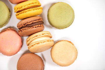 several multi-colored macaroon cakes on a white background