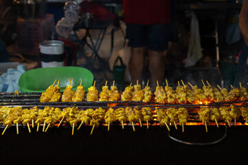Pork satay, Grilled pork on charcoal stove. Street food in Thailand.