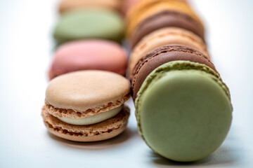 several multi-colored macaroon cakes on a white background