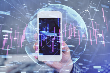 Double exposure of man's hands holding and using a digital device and forex graph drawing. Financial market concept.