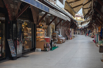 A long curving row at the Turkish tourist market in the heart of Istanbul. The counters are filled...