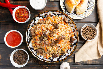 National Uzbek pilaf with meat in a cast-iron skillet