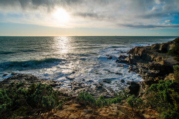 Fototapeta na wymiar A rocky coast with crashing waves