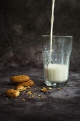 a glass of milk with cookies