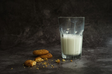 a glass of milk with cookies